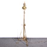 An English Art Nouveau lacquered brass and copper adjustable standard lamp, manner of Benson