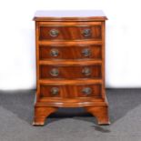 A reproduction mahogany serpentine chest,