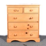 A modern pine chest of drawers,