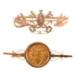 A Half Sovereign brooch and a sweetheart brooch.