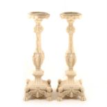 A pair of contemporary marbelized candle stands, in the Renaissance style