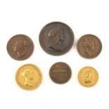 A collection of gilt bronze and bronze medals,
