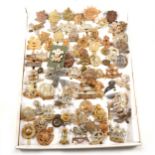 A collection of seventy-one military cap badges plus buttons.