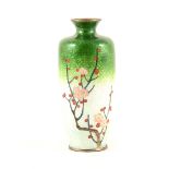 A small Japanese cloisonné vase, on white metal, decorated with blossom