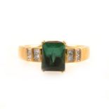 A green tourmaline and diamond ring.