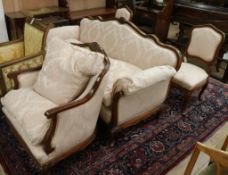 A modern carved mahogany suite on the Louis XV style covered in ivory brocade, comprising settee,