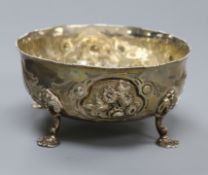 A Victorian repousse silver sugar bowl, on four pad feet, Daniel & Charles Houle, London, 1853,
