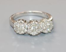 A triple cluster diamond ring (approx 1.02ct total) on white gold shank (tests as 18ct), size O/P