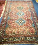 A Persian russet ground rug 270 x 164cm