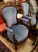 A pair of Victorian carved walnut open armchairs