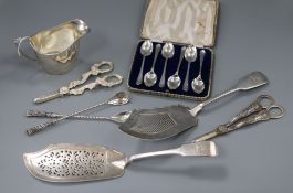 A George III silver cream jug, a George III silver fish slice, a pair of silver grape shears and