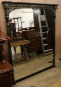 A Victorian ebonised and parcel gilt overmantel mirror, with arched plate flanked by reeded columns,