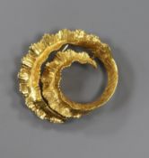 A 1970's 18ct gold brooch in the form of a coiled fern leaf, 11g, 37mm.