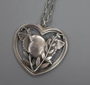 A Danish Georg Jensen sterling silver heart shaped robin and wheatsheaf pendant, no. 97 38mm, on a