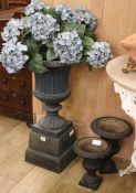 Three cast metal campana urns W.21cm, 23cm and 39cm