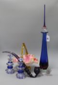 A pair of glass scent bottles, a glass spire shaped decanter, a glass pipe, a pair of glass bulldogs