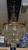 A gilt metal lustre four tier chandelier