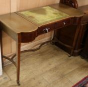 An Edwardian mahogany writing table, having leather skiver, bowed end compartments and frieze