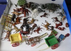 A collection of Britains and other horses, donkeys, carts, fencing, etc