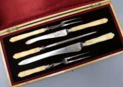 A cased ivory handled silver collared carving set