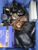 A box of assorted cameras and equipment