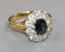 A 1970's 18ct gold, sapphire and diamond set oval cluster ring, size M.