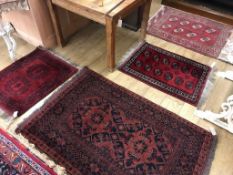 Three Bokhara rugs and a Belouch rug 120 x 92cm, 94 x 69cm, 159 x 101cm and 88 x 70cm