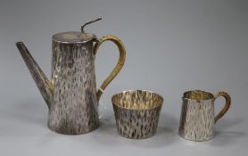 A matched late Victorian hammered silver three piece coffee set by Hukin & Heath, Birmingham, 1895 &