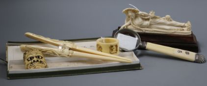 An Oriental carved ivory figure on wooden stand, a pair of boxed ivory glove stretchers, napkin