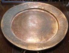 A large Persian embossed copper dish, late 19th/early 20th century, inscribed 81cm