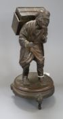 A Japanese spelter group of an elderly man carrying a large chest height 28cm