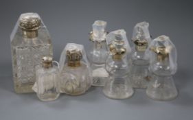 A collection of silver-mounted glass items, including a set of four whisky tots, a large square-