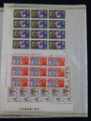 An accumulation of stamps in an album and loose in a box