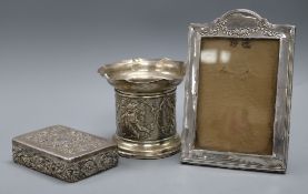 A late Victorian repousse silver bottle stand, a late Victorian silver box by William Comyns and a