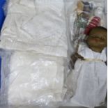 An Armand Marseille doll, two other dolls, christening gowns, etc.
