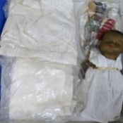 An Armand Marseille doll, two other dolls, christening gowns, etc.