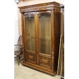 A late 19th century French walnut two door glazed bookcase W.142cm, H.215cm
