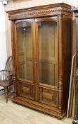 A late 19th century French walnut two door glazed bookcase W.142cm, H.215cm