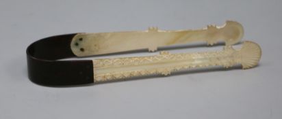 A pair of George III mother of pearl and tortoiseshell sugar tongs