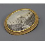 An Indian oval miniature on ivory painted with the Taj Mahal in a yellow metal mount, mount tests as