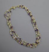 A modern 18ct gold and gem set triple strand necklace, set with amethyst, peridot etc, approx.