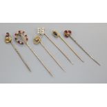 Six assorted mainly early 20th century yellow metal and gem set stick pins, including diamond set