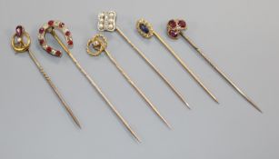 Six assorted mainly early 20th century yellow metal and gem set stick pins, including diamond set