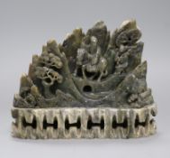 A Chinese soapstone carving depicting travellers crossing a landscape, height 17cm