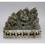 A Chinese soapstone carving depicting travellers crossing a landscape, height 17cm