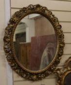 A Florentine carved gilt wood oval mirror W.50cm