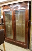 A 19th century French mahogany two door glazed bookcase W.156cm, H.216cm