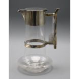 A Hukin and Heath silver plate mounted glass claret jug in the manner of Christopher Dresser, 22.