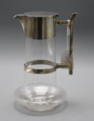 A Hukin and Heath silver plate mounted glass claret jug in the manner of Christopher Dresser, 22.