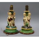 A pair of Minton majolica tazza bases, each modelled with three cherubs (converted as table